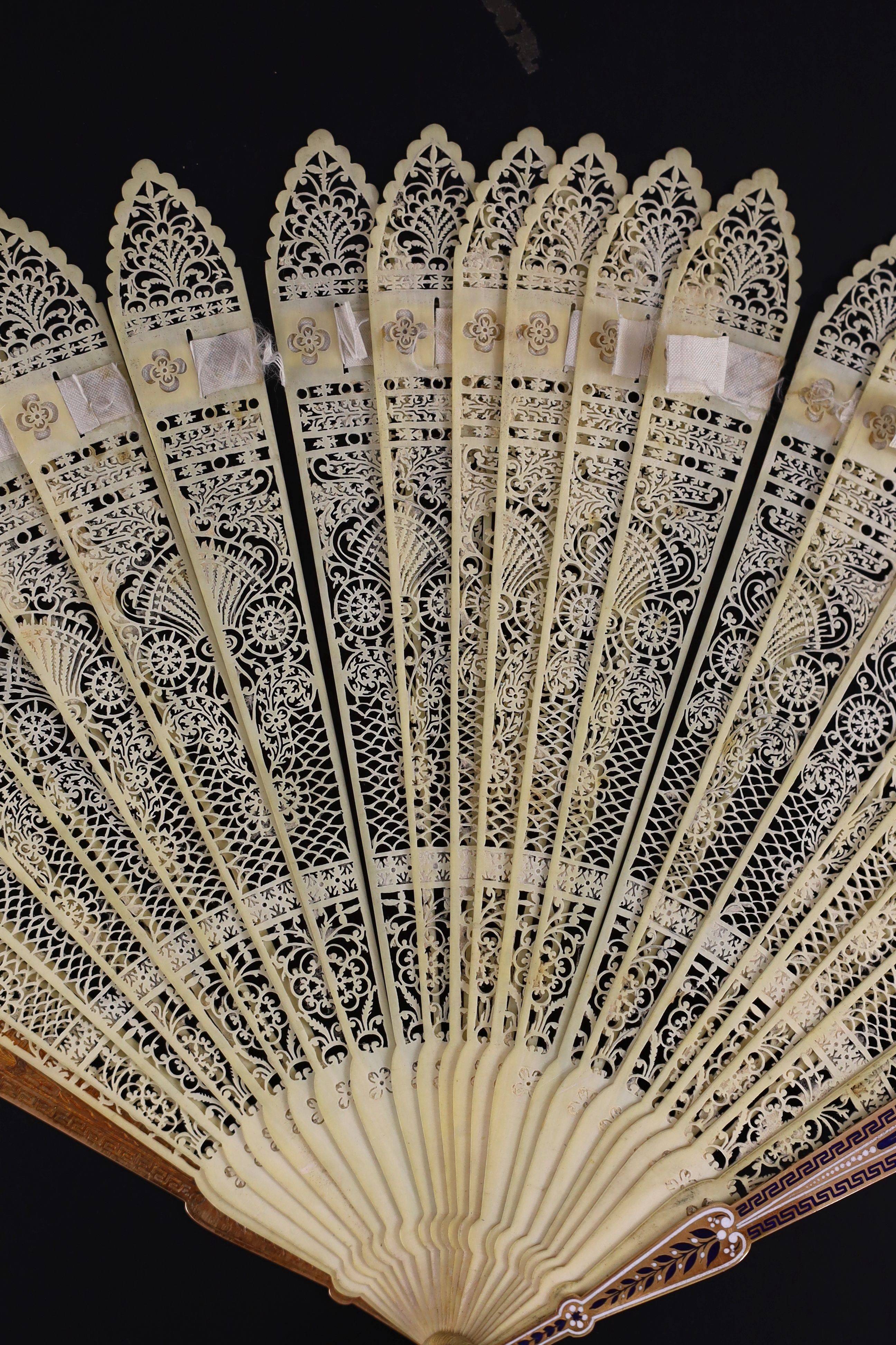 A German or Swiss gold, enamel and ivory brise fan, 19th century, possibly made for the Ottoman market, 17.3 cm closed, slight losses to sticks, needs rethreading